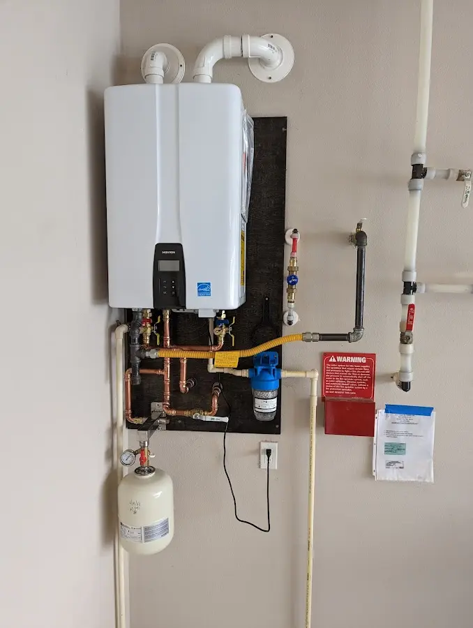 Professional plumber installing copper piping in a Anchorage home